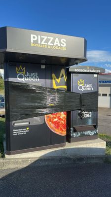 a vending machine that has a pizza on the front of it