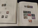 two open books with stamps on them on a table