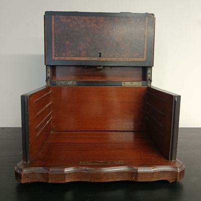 a wooden chest with a drawer on top of it
