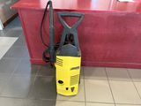 a yellow and black pressurer on the floor next to a red counter