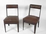 pair of brown leather dining chairs on a white background
