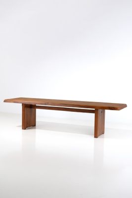 an image of a wooden bench against a white wall