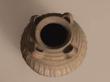 a small vase with a hole in the middle of it