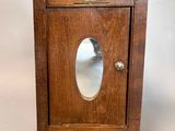 an old wooden cabinet with a mirror on top of it