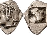 a silver coin with a face of a man and a head of a woman