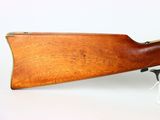 an old rifle with a wooden barrel on a white background