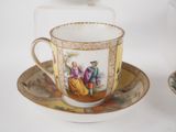 a cup and saucer with a picture of a man and a woman on it