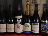 several bottles of wine are lined up on a table