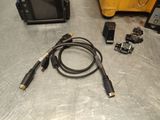 a couple of cables connected to a camera on a table