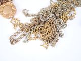 a gold and silver necklace with a coin on it