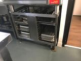 an image of a commercial kitchen with many trays of food in it