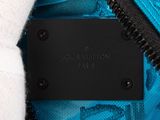 the inside of a blue louis vuitton bag with a black label