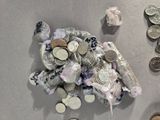 a pile of coins on the ground next to a pile of coins