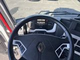 a steering wheel and dashboard of a vehicle in a parking lot