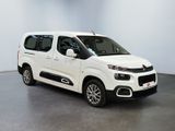 the white van is parked in a room with a white wall