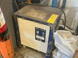an image of a refrigerator in a garage with a fire extinguisor