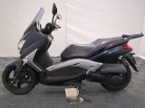 a picture of a scooter that is parked on a checkered floor