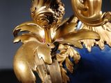 a gold and blue vase with a bird on it