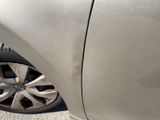 a close up of a car ' s tire with a hole in it