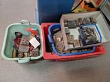 two bins filled with assorted items sitting on the floor