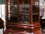 a display case with a piano and a piano in the background