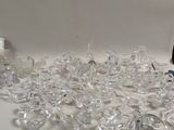 a pile of clear glasses sitting on a table