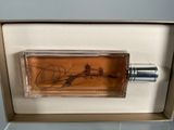 perfume bottle in a box with a drawing of a lighthouse
