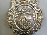 a silver plate with a picture of a man and a woman on it