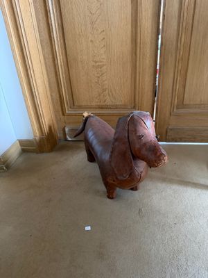 a small dog that is standing in front of a door