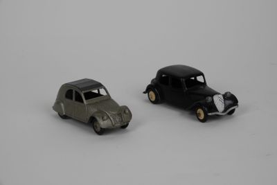 two toy cars sitting next to each other on a white surface
