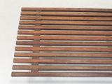 a close up of a wooden slatt on a white surface