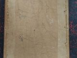 an old picture of a box with a drawing on it sitting on a table