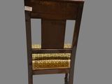 a wooden chair with a yellow seat on a gray background