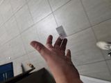 a person that is holding a piece of paper in their hand