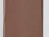 a brown leather notebook on a white surface with a white background