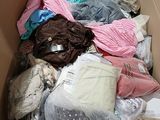 a cardboard box filled with clothes and other items