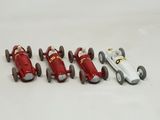 several toy cars are lined up in a row on a white surface