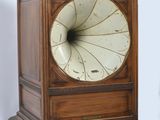a wooden clock that is sitting on a table