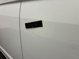 a sticker on the door of a white car