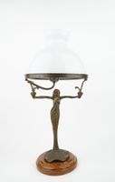 Lampe en bronze à décor de femme nue et jupe feuillage