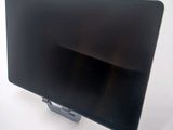 a tablet computer sitting on a stand on a white surface