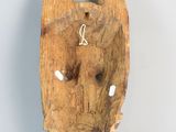 a wooden sculpture of an elephant head on a table