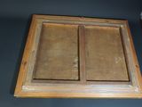 an old wooden window frame with two open doors on a blue wall