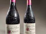 two bottles of wine sitting on top of a table next to each other