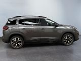 the grey suv is parked in a room with a gray floor