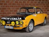 yellow and black car parked in front of a brick wall