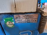 a close up of a blue machine with a sticker on it