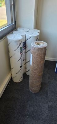 several rolls of toilet paper sitting next to a window in a room