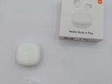 a box of earphones and a pair of ear buds