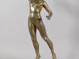 bronze statue of a woman holding a key in her right hand